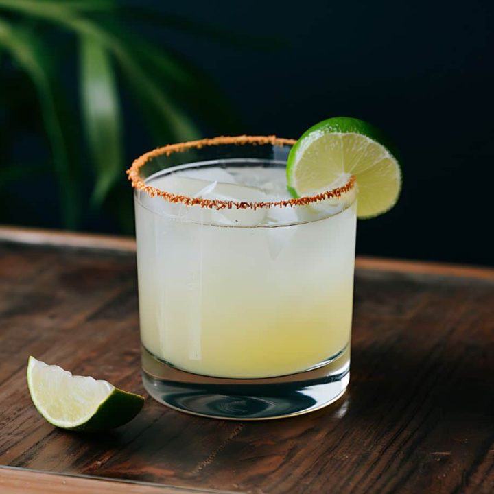 a margarita cocktail in a rocks glass garnished with a lime representing the best classic margarita recipe